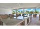 The outdoor kitchen at the community pool provides barstool seating, ceiling fans, and lovely views at 33030 Major Oak Dr, Wesley Chapel, FL 33545