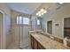 Bathroom featuring a shower and granite countertop for a luxurious bathing experience at 3315 Granite Ridge Loop, Land O Lakes, FL 34638