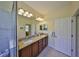 Bathroom with dual sinks, a granite countertop, and a shower for a luxurious experience at 3315 Granite Ridge Loop, Land O Lakes, FL 34638