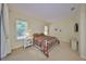 Bright bedroom with a large window, plush carpeting, and a comfortable bed creates a peaceful retreat at 3315 Granite Ridge Loop, Land O Lakes, FL 34638