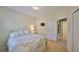 Comfortable bedroom with a floral-patterned bedspread, an open doorway, and neutral walls offering a peaceful retreat at 3315 Granite Ridge Loop, Land O Lakes, FL 34638