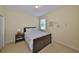 Comfortable bedroom with a bedside table, decor, and soft carpet for a relaxing space at 3315 Granite Ridge Loop, Land O Lakes, FL 34638