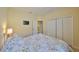 Cozy bedroom with floral bedding, closet, and TV for relaxation and comfort at 3315 Granite Ridge Loop, Land O Lakes, FL 34638