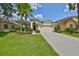 Charming single-story home with a two-car garage and lush green lawn at 3315 Granite Ridge Loop, Land O Lakes, FL 34638