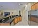 Spacious kitchen has stainless appliances, granite counters, wood cabinets and white tiled floor at 3315 Granite Ridge Loop, Land O Lakes, FL 34638