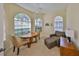 Inviting living room with ample natural light from three windows, ceiling fan, and comfortable seating at 3315 Granite Ridge Loop, Land O Lakes, FL 34638