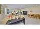 Open-plan living and dining room with neutral walls boasts tile floors and lots of natural light at 3315 Granite Ridge Loop, Land O Lakes, FL 34638