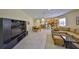 Open-concept living space features tile flooring and a dining area adjoining a comfortable seating area with a large entertainment center at 3315 Granite Ridge Loop, Land O Lakes, FL 34638