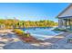 Community pool area featuring clear blue water, lounge chairs, and landscaping at 3315 Granite Ridge Loop, Land O Lakes, FL 34638
