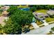 An aerial view of the property shows a home with driveway, mature trees, and a pond in a neighborhood at 3414 Rankin Dr, New Port Richey, FL 34655