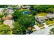 An aerial shot displaying the home with mature trees, and beautiful pond in this peaceful neighborhood at 3414 Rankin Dr, New Port Richey, FL 34655
