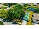 An aerial view of the charming single-Gathering home with a beautiful pond and mature landscaping at 3414 Rankin Dr, New Port Richey, FL 34655