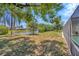 Expansive backyard featuring a serene pond view, lush greenery, and ample space at 3414 Rankin Dr, New Port Richey, FL 34655