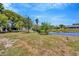 Lush backyard features a serene pond view and ample space for outdoor enjoyment at 3414 Rankin Dr, New Port Richey, FL 34655