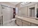 Bright bathroom with updated vanity, tiled shower, and large mirror at 3414 Rankin Dr, New Port Richey, FL 34655