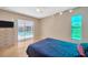 Bedroom featuring a sliding glass door to the pool, tan walls, and modern ceiling fan at 3414 Rankin Dr, New Port Richey, FL 34655