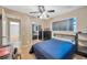 Bedroom with a blue accent wall, closet with mirrored doors, and natural light from the window at 3414 Rankin Dr, New Port Richey, FL 34655