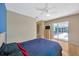 Bright bedroom features wood floors, ceiling fan, and sliding glass doors to the pool area at 3414 Rankin Dr, New Port Richey, FL 34655