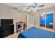 Bedroom with a blue accent wall, built-in desk, closet with mirrored doors, and TV at 3414 Rankin Dr, New Port Richey, FL 34655