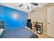 Bedroom featuring a blue accent wall, with a TV, a study desk, and ample space at 3414 Rankin Dr, New Port Richey, FL 34655