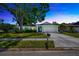 Charming single-story home with mature landscaping, a well-manicured lawn, and an attached two-car garage at 3414 Rankin Dr, New Port Richey, FL 34655