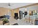 Living room with an adjacent kitchen featuring stainless steel appliances, white cabinetry, and counter seating at 3414 Rankin Dr, New Port Richey, FL 34655