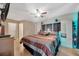 Spacious bedroom with ceiling fan, wood-look floors, and ample closet space at 3414 Rankin Dr, New Port Richey, FL 34655