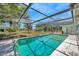 Sparkling screened-in pool with spacious deck and lush backyard views, perfect for relaxation and entertaining at 3414 Rankin Dr, New Port Richey, FL 34655