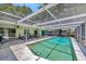 Large screened-in pool surrounded by a patio area, ideal for outdoor gatherings and enjoying the Florida sunshine at 3414 Rankin Dr, New Port Richey, FL 34655