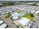 Expansive aerial view showcasing the community pool, clubhouse, and well-maintained homes at 34506 Rose N Dr, Pinellas Park, FL 33781