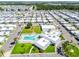 Wide aerial view of a vibrant community highlighting the swimming pool and common area at 34506 Rose N Dr, Pinellas Park, FL 33781