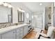 Bathroom featuring double sinks, modern fixtures, and a glass-enclosed shower at 34506 Rose N Dr, Pinellas Park, FL 33781