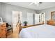 Bedroom with hardwood floors, a wooden bed frame, and multiple doorways at 34506 Rose N Dr, Pinellas Park, FL 33781