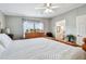 Comfortable bedroom with a wood bed frame, hardwood floors, and an ensuite bathroom at 34506 Rose N Dr, Pinellas Park, FL 33781