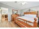 Bedroom featuring hardwood floors, a wooden bed frame, and a view into another room at 34506 Rose N Dr, Pinellas Park, FL 33781