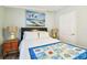 Bedroom featuring beach-themed artwork and lamps, and a quilt covered bed at 34506 Rose N Dr, Pinellas Park, FL 33781