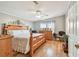 Inviting bedroom with hardwood floors, a ceiling fan, and a decorative headboard at 34506 Rose N Dr, Pinellas Park, FL 33781