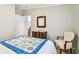Bedroom featuring a quilt covered bed and antique dresser with mirror at 34506 Rose N Dr, Pinellas Park, FL 33781