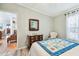 Cozy bedroom featuring a quilt covered bed and antique dresser with mirror at 34506 Rose N Dr, Pinellas Park, FL 33781