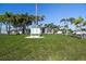 Community center with palm trees and manicured lawn providing a welcoming space for residents and activities at 34506 Rose N Dr, Pinellas Park, FL 33781