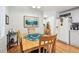 Cozy dining area featuring wood floors, a kitchen pass-through, and access to appliances at 34506 Rose N Dr, Pinellas Park, FL 33781