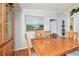 Dining room featuring a wooden table and chairs, complemented by wall decor and natural light at 34506 Rose N Dr, Pinellas Park, FL 33781