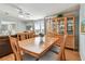 Dining area with a wood table, chairs, and display cabinet, connecting to the living room for an open feel at 34506 Rose N Dr, Pinellas Park, FL 33781