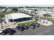 Aerial view of a clubhouse with covered picnic area featuring ample parking and landscaped grounds at 34506 Rose N Dr, Pinellas Park, FL 33781