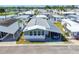 Manufactured home featuring a convenient carport and manicured landscaping within a peaceful neighborhood at 34506 Rose N Dr, Pinellas Park, FL 33781