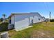 Home exterior with siding, small round window, and utilities access at 34506 Rose N Dr, Pinellas Park, FL 33781