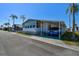 Charming manufactured home featuring a covered carport and well-maintained landscaping at 34506 Rose N Dr, Pinellas Park, FL 33781