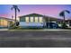 Charming manufactured home featuring a covered carport and well-maintained landscaping at 34506 Rose N Dr, Pinellas Park, FL 33781