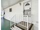 Inviting front entrance with white door and modern railing on a covered porch at 34506 Rose N Dr, Pinellas Park, FL 33781