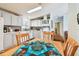 Inviting kitchen and dining area with white cabinetry, modern appliances and a view to the living room at 34506 Rose N Dr, Pinellas Park, FL 33781